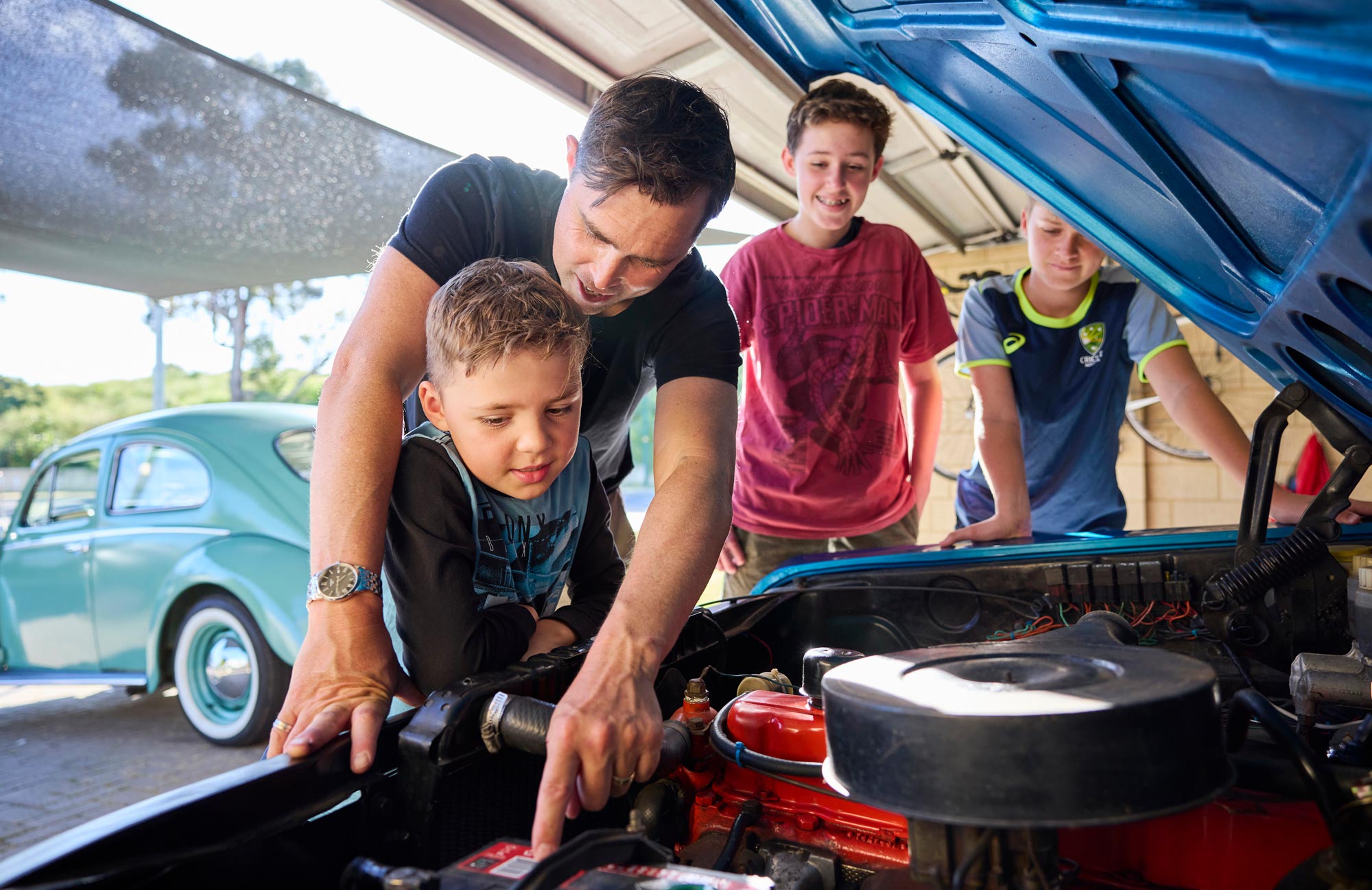 Prostate Cancer Survivor Ross working on his car with his three boys Prostate Cancer Survivor Ross working on his car with his three boys
